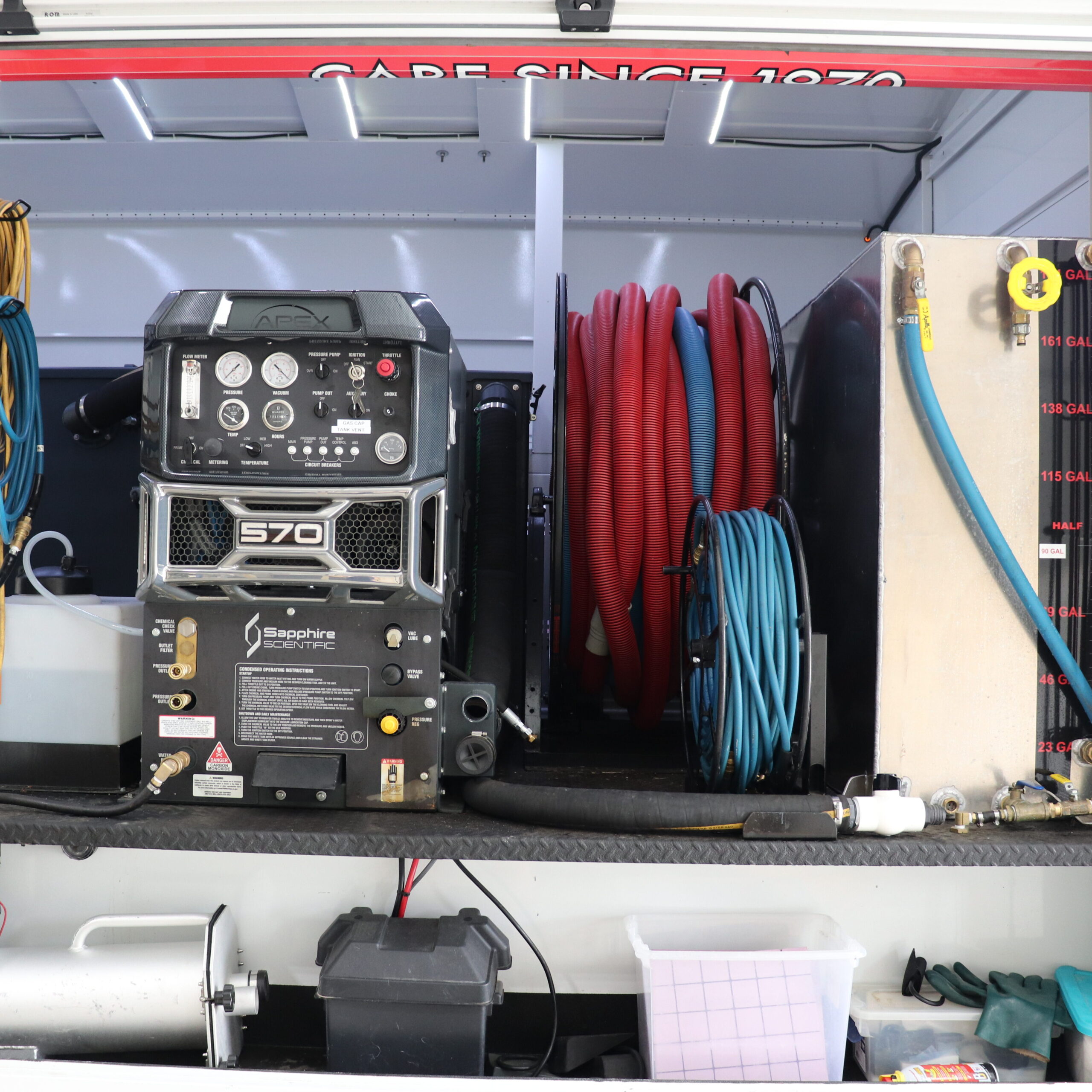 Truck compartment with our Sapphire Scientific Apex 570 machine and cleaning supplies arranged on shelves—ready to handle jobs in Floyd Knobs and nearby Louisville or Corydon.